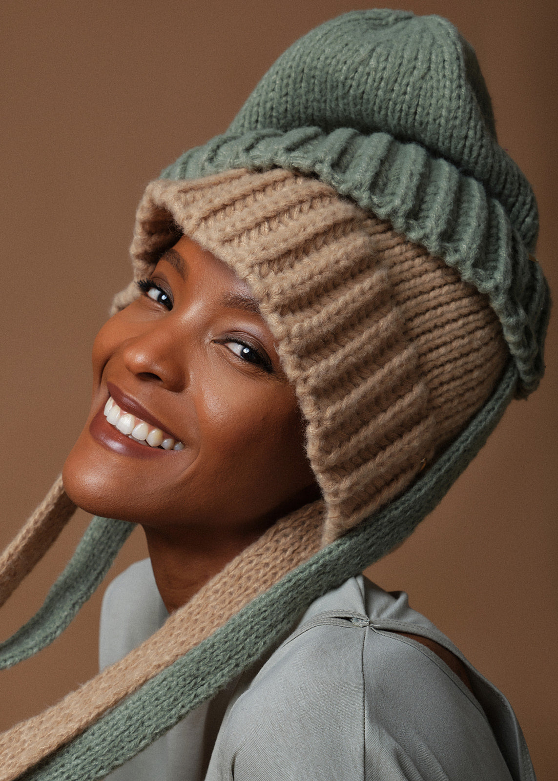 Our own spin on the cottagecore look, this charming knit hat can be styled as a beanie or a bonnet. Pull down the ribbed band closer to your eyes and let the tie hang loose or slip it to the back of your head and tie the “ribbons” into a bow.      Beige (also available in mint)     Ribbed cuff, wide tie